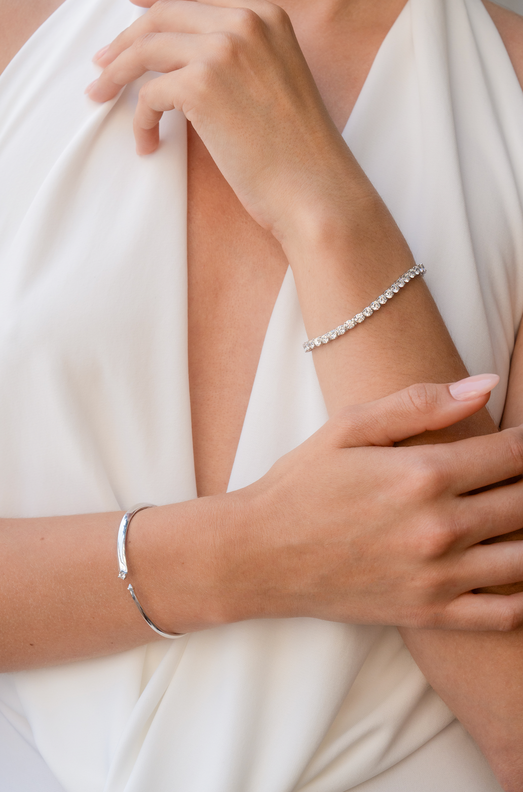 woman's arms with diamond bracelets