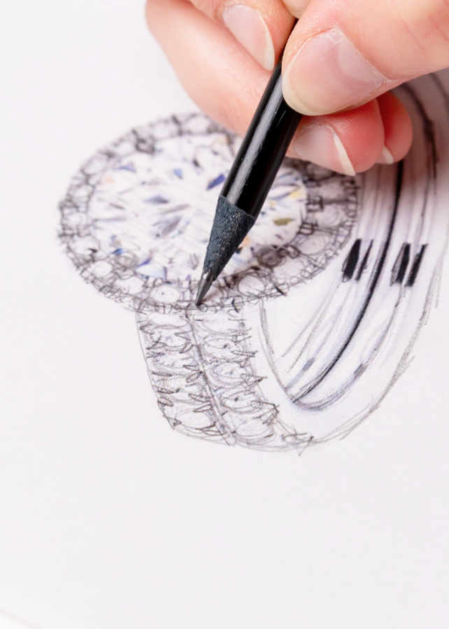 ring being designed on paper with a pencil